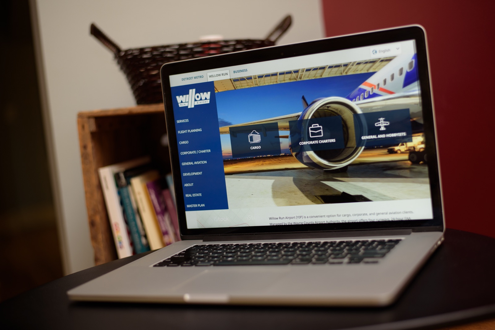 The Willow Run Airport website on a laptop